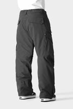 A person shown from the back wears the 686 Men's SMARTY® 3-in-1 Cargo Pant—loose-fitting, dark gray with a removable sweatpant liner, paired with black-and-white sneakers—offering three ways to wear by 686, against a plain light gray background.