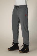 A person wearing 686 Men's SMARTY® 3-in-1 Cargo Pant in gray with a drawstring waist, black hiking boots with brown soles, and a white shirt; only the lower body is visible. These pants have a removable sweatpant liner for versatile wear.
