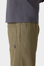 A person wearing a grey shirt and 686 Everywhere® Pant - Slim Fit by 686.