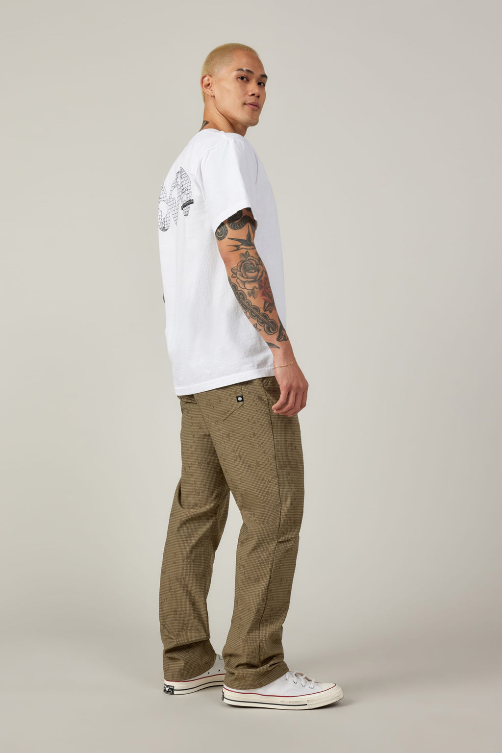 A man in a white shirt completes his look with 686's Everywhere® Pant - Relaxed Fit for all-day comfort.
