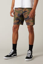 A person wears a white t-shirt, 686 Everywhere® Hybrid Shorts in camouflage, black crew socks, and black high-top sneakers against a plain light background; only the lower half of the body is visible.