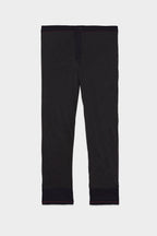The 686 Men's Everywhere® Merino-Lined Pant - Slim Fit in dark gray, featuring a black waistband and cuffs, offers warmth and comfort for cold conditions. Displayed laid flat on a white background.