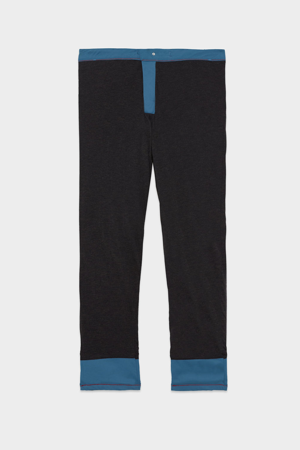 The 686 Men's Everywhere® Merino-Lined Pant - Relaxed Fit by 686 features black fabric with blue trim at the waistband, fly, and cuffs—ideal for pairing with your insulated outerwear for a sharp winter ensemble.