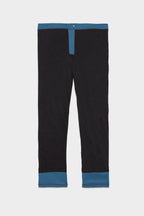 The 686 Men's Everywhere® Merino-Lined Pant - Relaxed Fit by 686 features black fabric with blue trim at the waistband, fly, and cuffs—ideal for pairing with your insulated outerwear for a sharp winter ensemble.