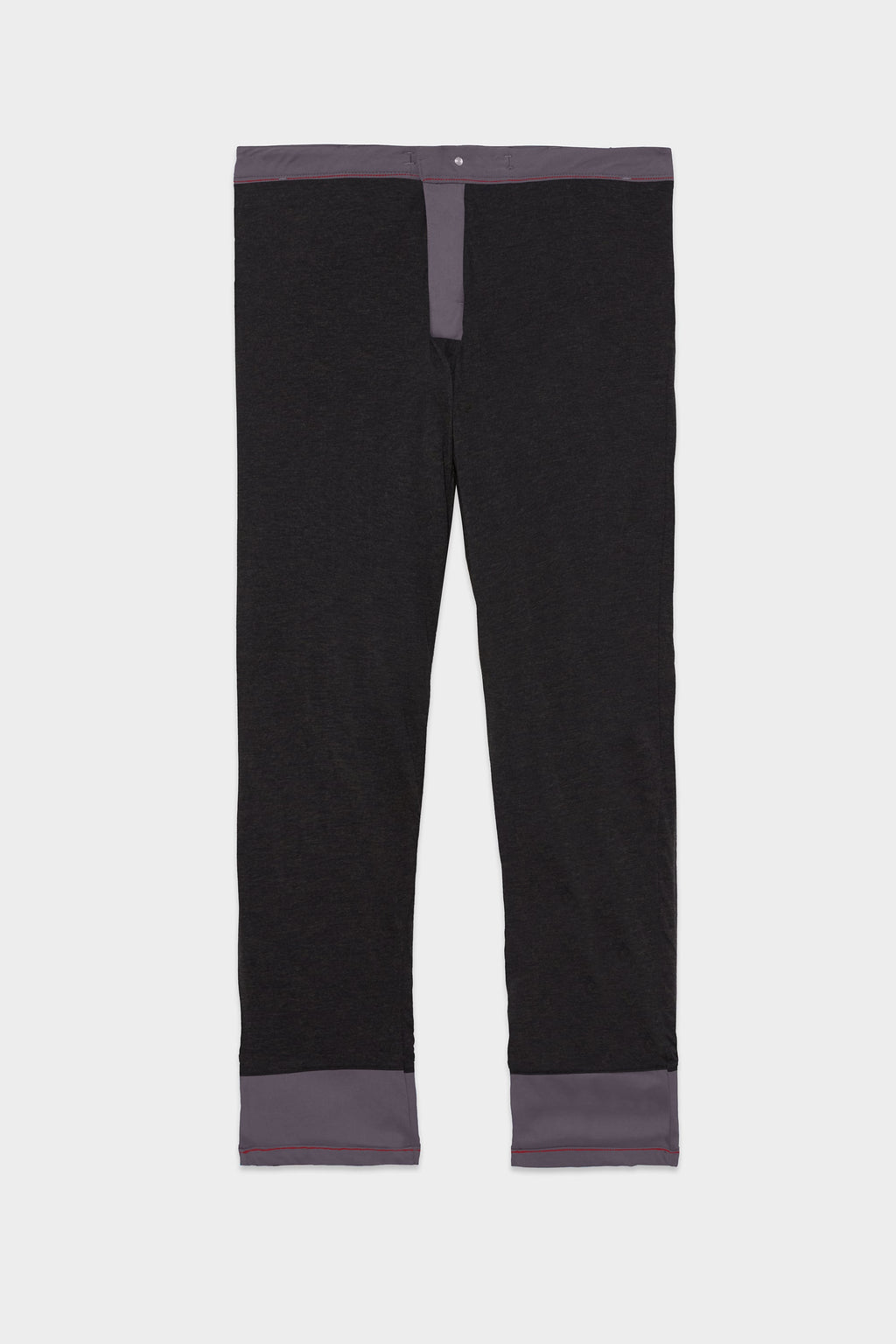 The 686 Men's Everywhere® Merino-Lined Pant - Relaxed Fit features black straight legs with gray cuffs, waistband, and fly—perfect for pairing with your favorite winter jacket for a cozy cold-weather ensemble.
