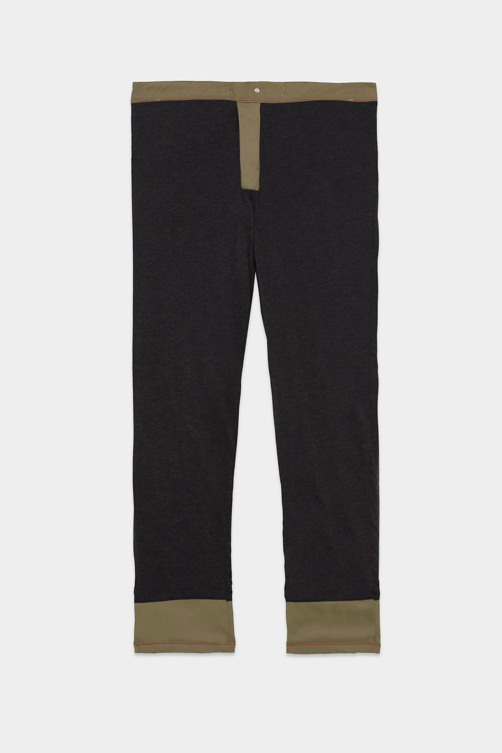 The 686 Men's Everywhere® Merino-Lined Pant - Slim Fit, in black with olive green accents on the waistband, fly, and cuffs, is designed to keep you warm and dry in colder conditions, shown laid flat on a white background.