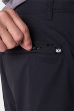 A person's hand slipping a pocket on the 686 Everywhere® Featherlight Chino Short by 686.