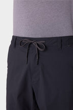 A person wears a light gray t-shirt with 686 Men's Everywhere® Featherlight Chino Shorts, featuring an adjustable drawstring waistband, belt loops, and a breathable design. The image highlights the shorts' waist and upper legs. Brand: 686.