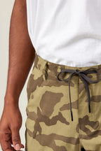 A person is wearing a white t-shirt and 686 Men's Everywhere® Featherlight Chino Short; the photo shows their torso and part of one arm.