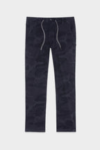 The 686 Mens Everywhere Featherlight Chino Pant - Slim Fit by 686 features a dark blue camo pattern, drawstring waist, front button, and side pockets—ideal lightweight pants for casual summer wear or warm weather adventures.