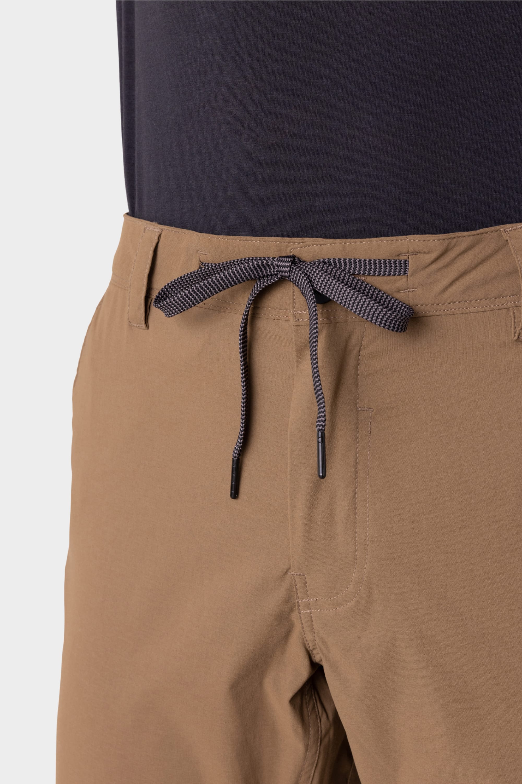 Close-up of someone wearing 686 Men's Everywhere® Featherlight Chino Pant - Slim Fit in tan, featuring a black-and-white drawstring, front pocket, and lightweight, breathable fabric—ideal for summer style.
