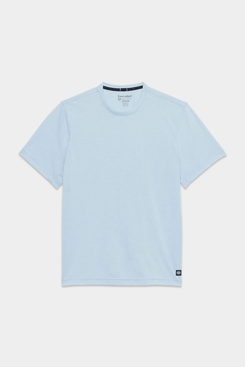 The 686 Mens Everywhere drirelease® Tech Tee, a light blue short-sleeve crew neck by 686, is displayed flat on a white background with a small black tag near the bottom hem on one side.