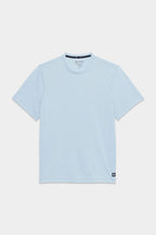 The 686 Mens Everywhere drirelease® Tech Tee, a light blue short-sleeve crew neck by 686, is displayed flat on a white background with a small black tag near the bottom hem on one side.