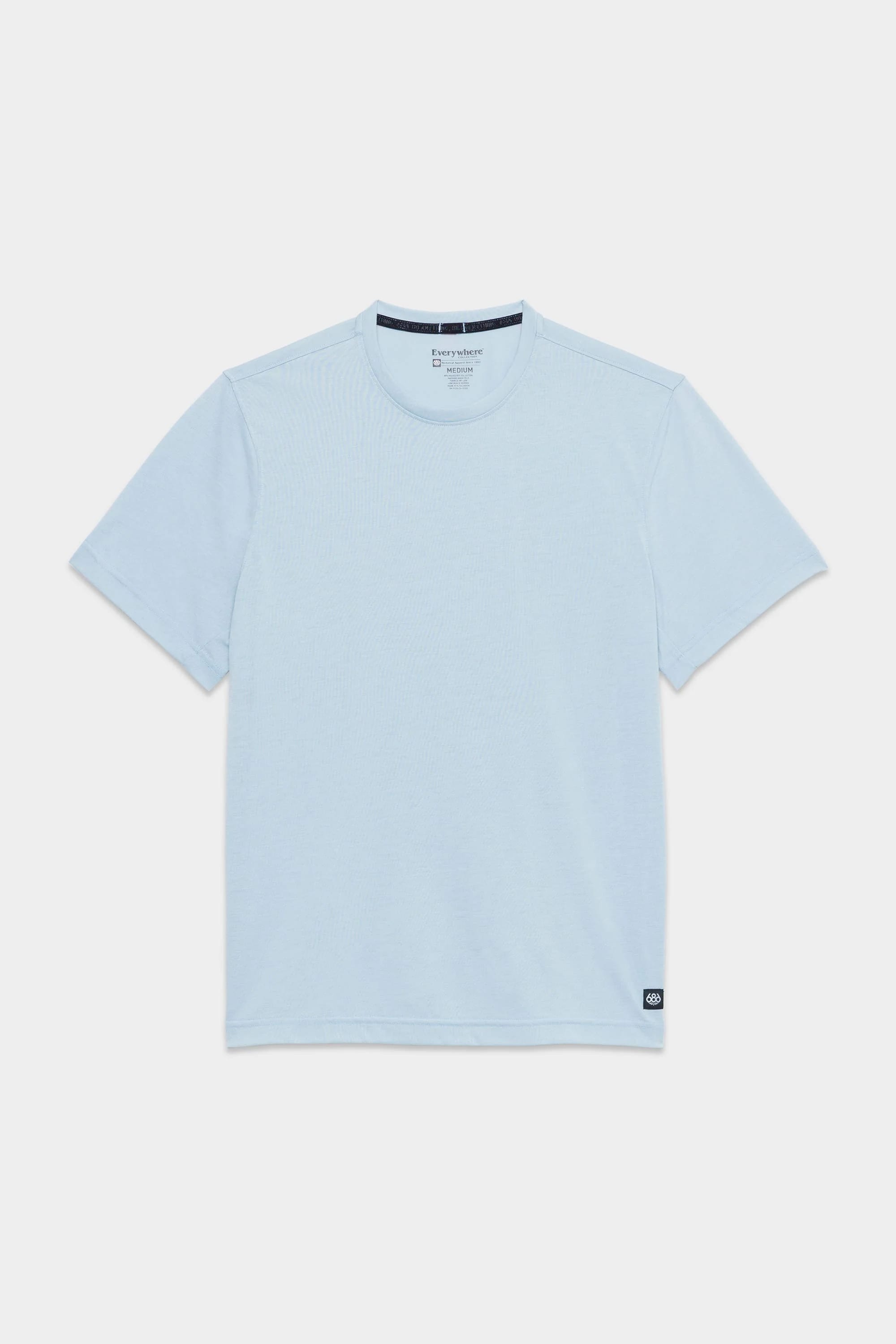 The 686 Mens Everywhere drirelease® Tech Tee, a light blue short-sleeve crew neck by 686, is displayed flat on a white background with a small black tag near the bottom hem on one side.