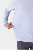 A man wearing the 686 Mens Everywhere drirelease® Long Sleeve Hooded Tech Tee in light blue tugs at his shirts side near the front pocket, showing off its stretch.