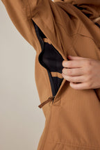 A close-up shows a hand unzipping the underarm vent of a 686 Womens Spirit Insulated Jacket, revealing its black mesh lining.