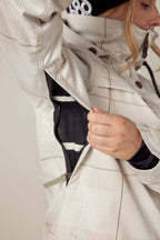 A person unzips the underarm ventilation of the 686 Womens Spirit Insulated Jacket, revealing black mesh lining inside.