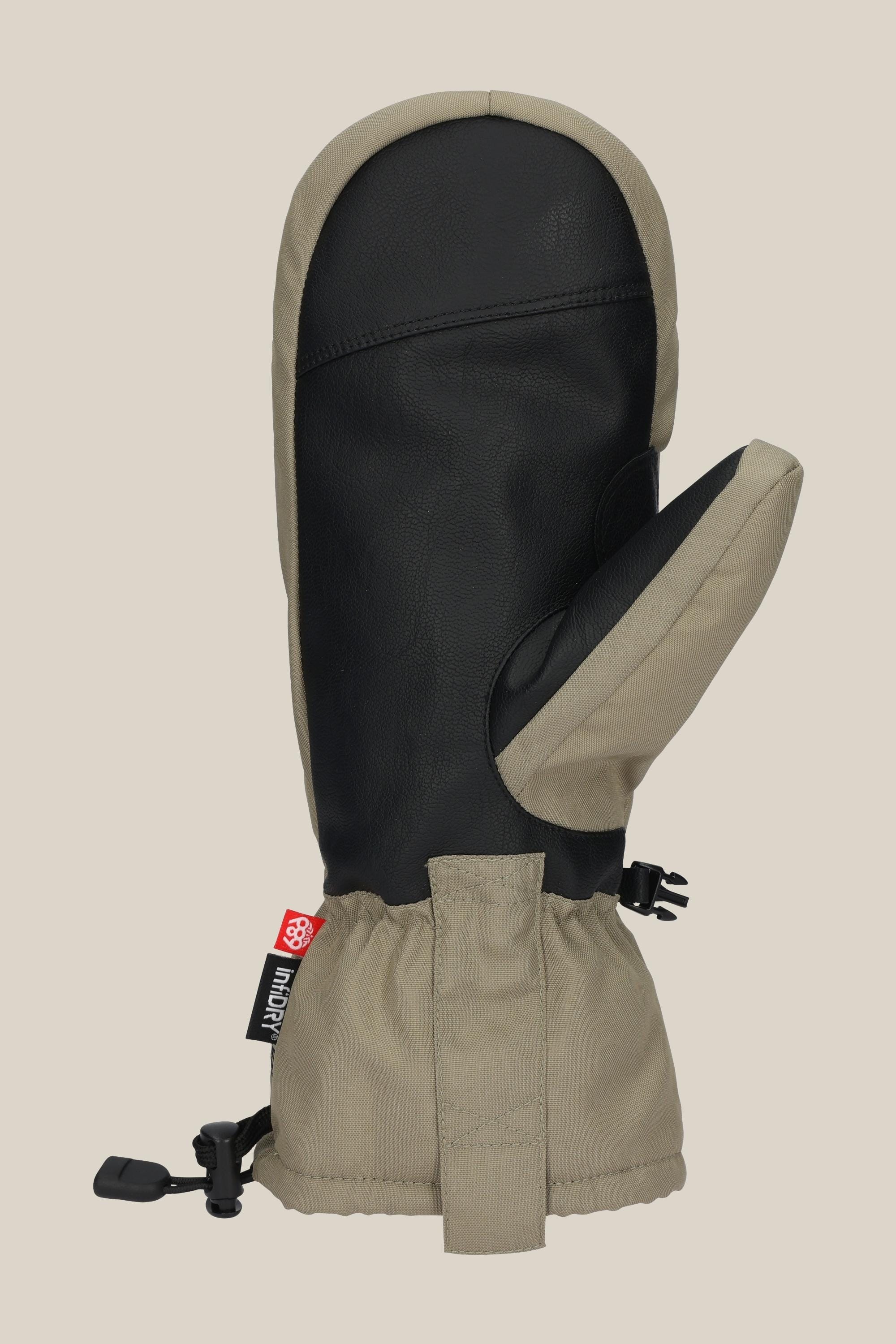 The 686 Lander™ Mitt by 686 features a black leather palm and thumb, beige fabric on the back and cuff, light insulation, waterproof design, adjustable strap, and a small red-and-white tag near the wrist.
