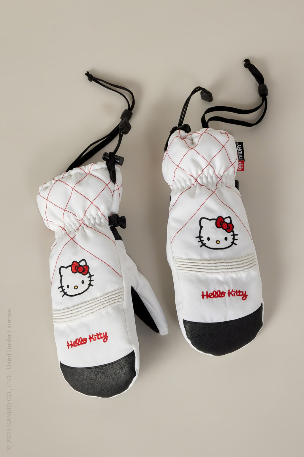 The 686 Women's Jubilee™ Mitt by 686 features white fabric with red stitching, black palms, Hello Kitty embroidery, a red bow, adjustable drawstrings, and light insulation for warmth and dryness.