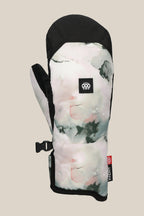 The 686 Womens Revel Mitt is a winter insulated mitt with a soft watercolor pattern in pastel pink, gray, and black, detailed with a small black-and-white paw print logo on the back and a red-and-white fabric tag on the cuff.