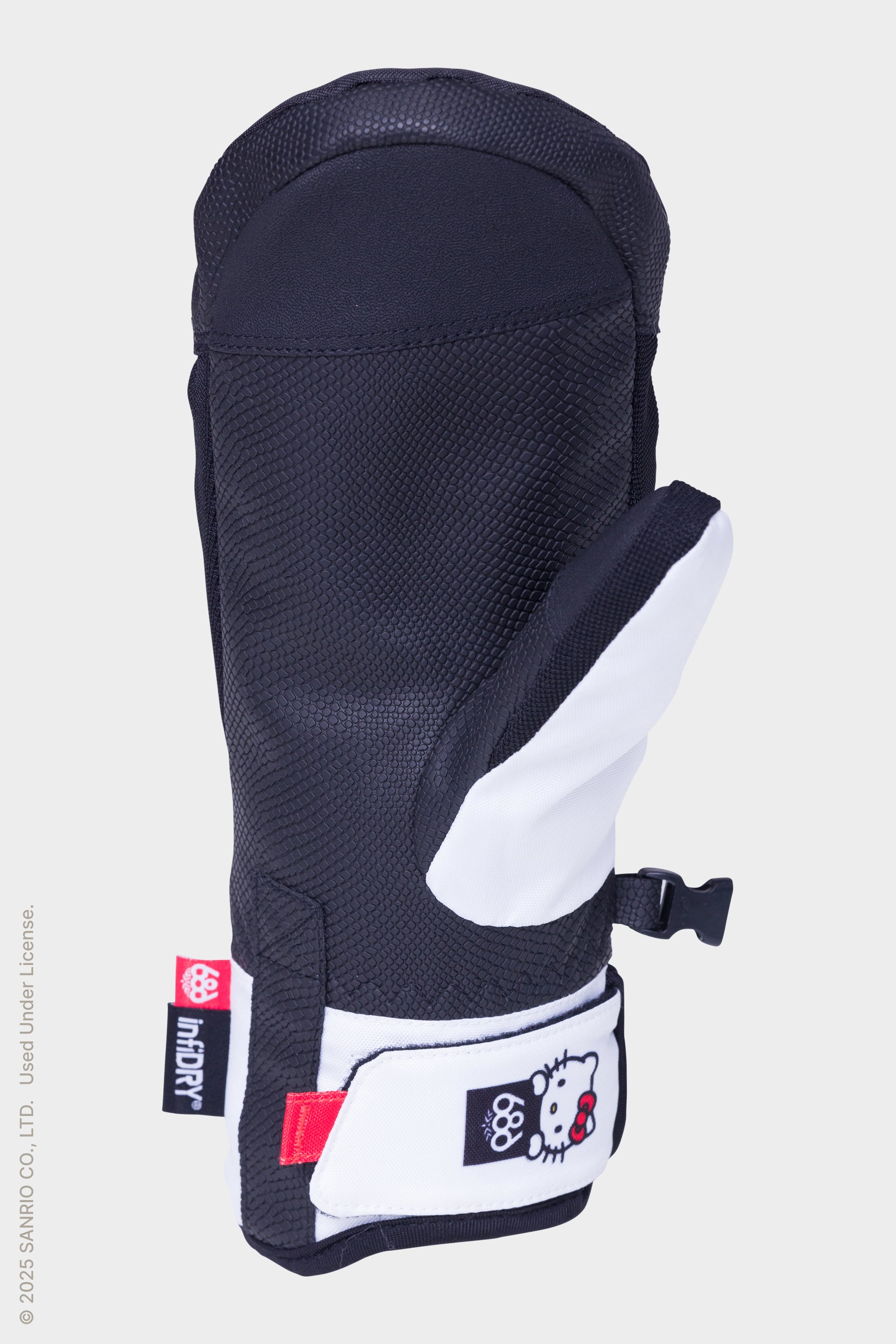 The 686 Womens Revel Mitt by 686 is a black and white insulated mitten featuring a Hello Kitty patch with Olympic rings, displayed against a plain light background.