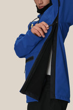 A person in a 686 Mens Waterproof Hoody by 686 unzips the large side zipper, showing the black fleece-lined interior. Their face is partly visible against a plain beige background.