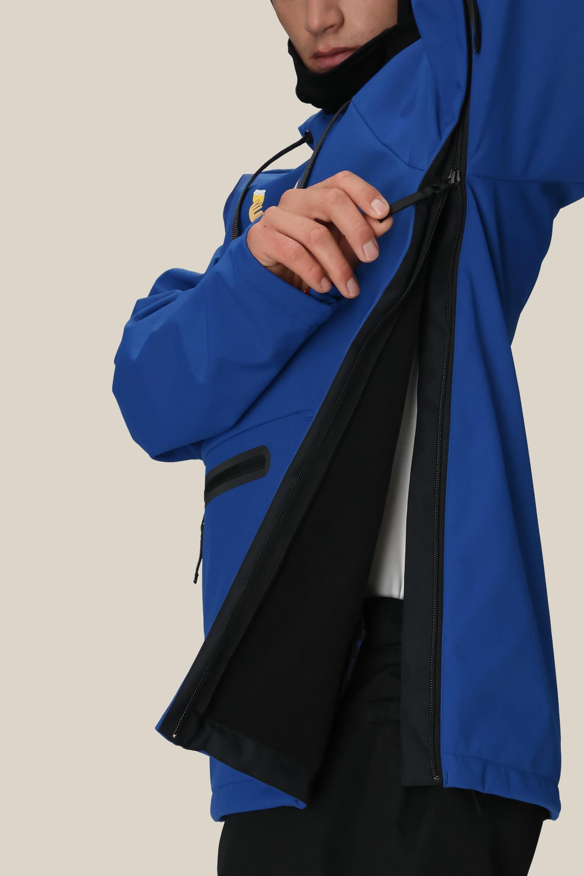 A person in a 686 Mens Waterproof Hoody by 686 unzips the large side zipper, showing the black fleece-lined interior. Their face is partly visible against a plain beige background.