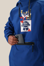 A person in a royal blue, fleece-lined 686 Mens Waterproof Hoody puts a smartphone into the front zippered pocket. The hoody features a large Pabst Blue Ribbon logo and a cartoon holding beer and pretzels.