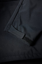 Close-up of the 686 Mens Waterproof Hoody sleeve shows a black velcro strap at the cuff, emphasizing its waterproof fabric, detailed stitching, and fleece-lined interior by 686.