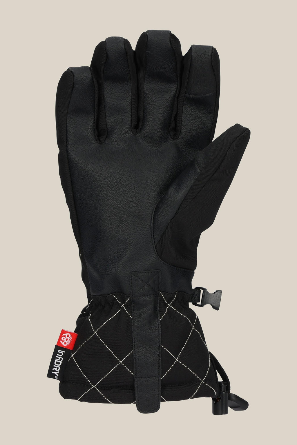 The 686 Women's Jubilee™ Glove by 686 features a black leather palm, quilted wrist, adjustable strap, and red branded tag, displayed on a plain beige background.