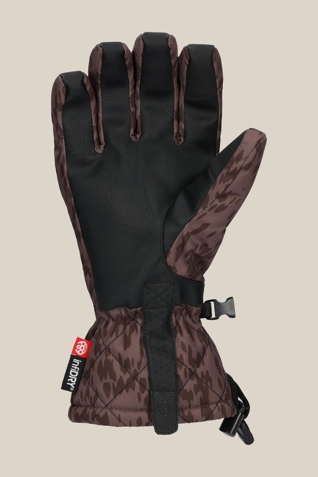 The 686 Women's Jubilee™ Glove by 686 features brown and black insulation, a textured pattern, adjustable strap, black grip palm, and a small red and white logo tag near the cuff. Shown flat with the palm facing up.