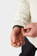 A person adjusts the sleeve of the 686 Men's Thermaldry™ Snap-Up Shirt, revealing part of their hand and wrist against a plain background.