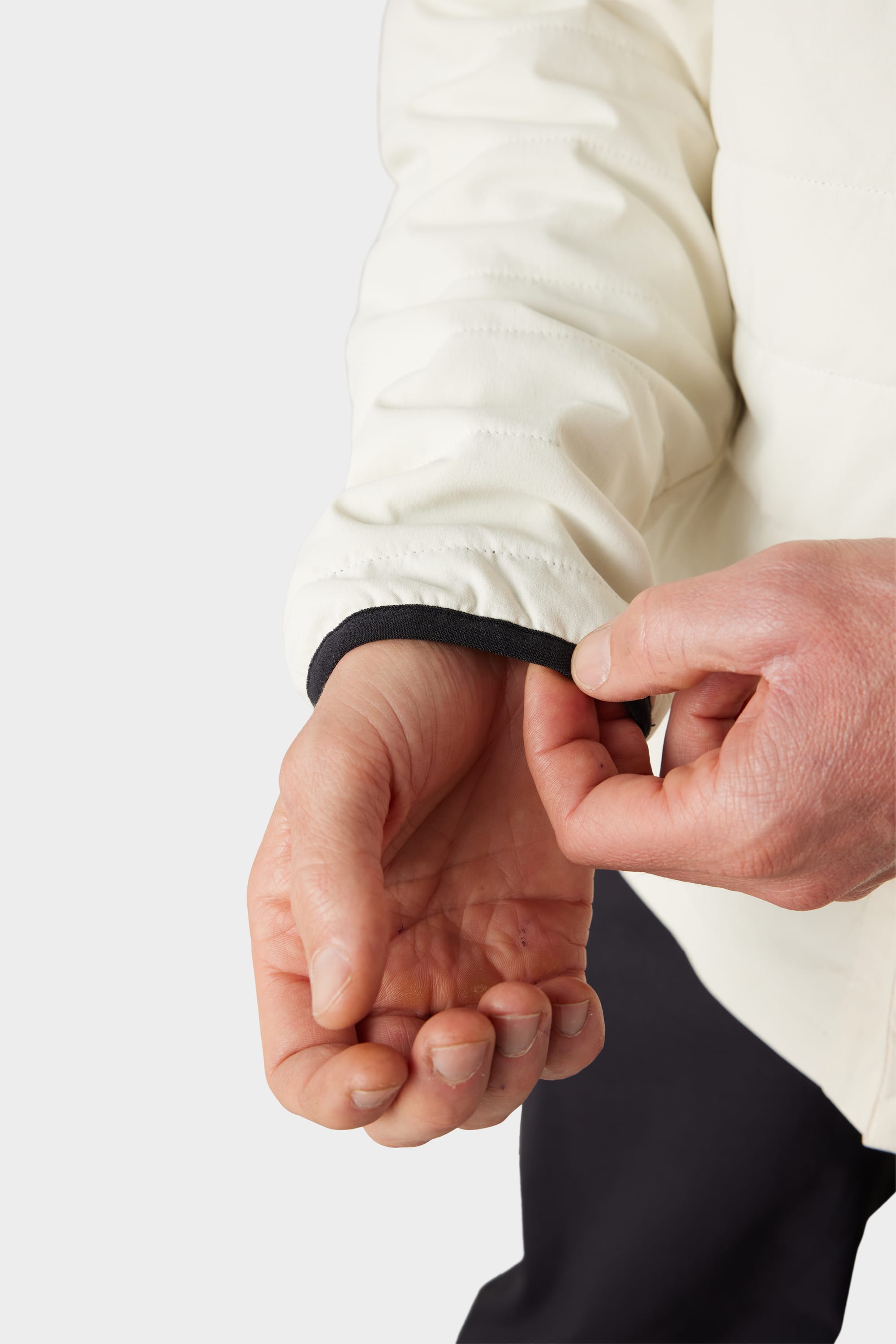 A person adjusts the sleeve of the 686 Men's Thermaldry™ Snap-Up Shirt, revealing part of their hand and wrist against a plain background.