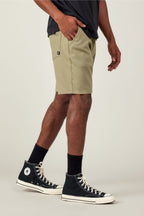A person wearing a black t-shirt, 686 Men's Everywhere® Ripstop Short by 686, black socks, and black high-top Converse sneakers stands with one hand in their pocket against a plain light background.