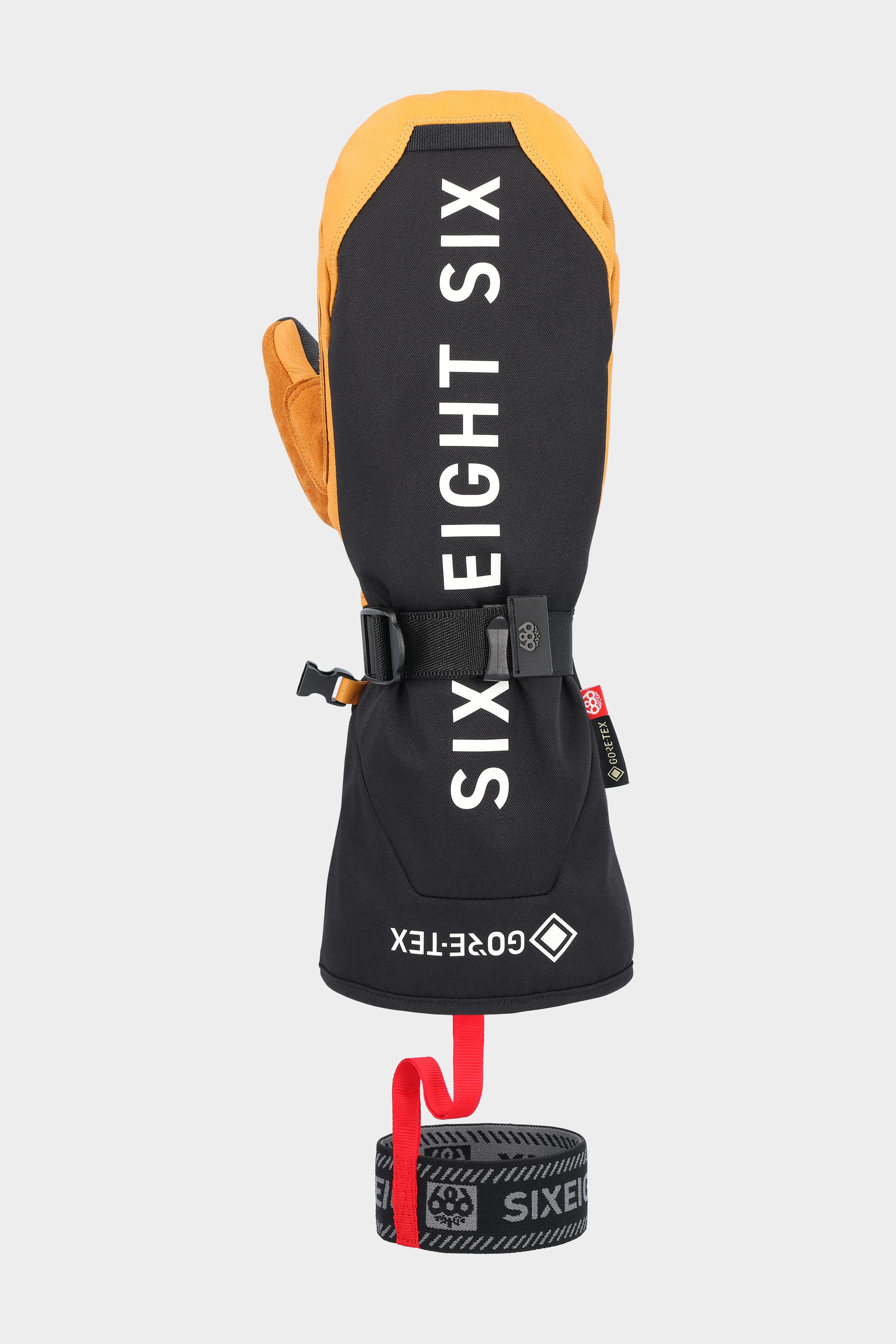 The 686 Men's GORE-TEX Leather Deep Days™ Mitt, in black and tan leather, features GORE-TEX waterproofing, a wrist cinch strap, detachable wrist leash with red pull tab, and SIX EIGHT SIX branding on a plain light background.
