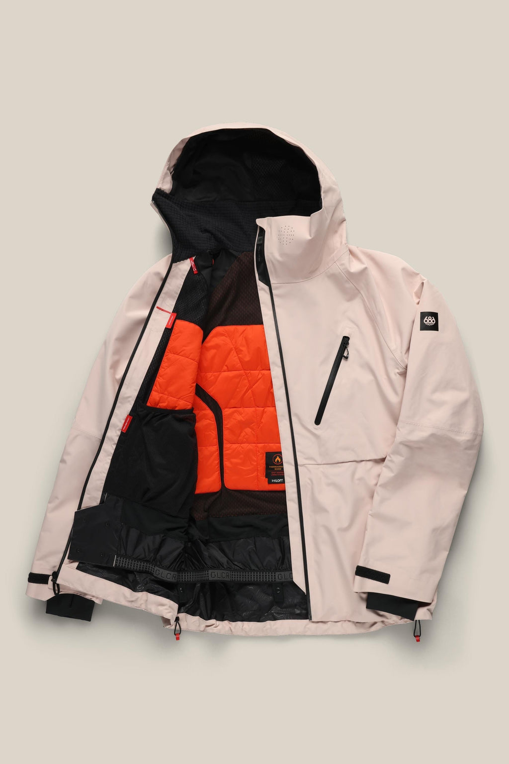 The 686 Men's Hydra™ Thermagraph® Jacket by 686 features a light pink exterior, an open front with a bright orange body-mapped lining, multiple black pockets including a zippered chest pocket, and a logo patch on the left sleeve.