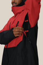 A person wearing the 686 Men's Hydra™ Thermagraph® Jacket by 686 unzips an underarm vent, showing the body-mapped mesh lining inside. Only the lower half of their face and torso are visible.