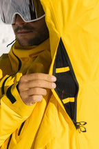 A person in the 686 Men's Hydra™ Thermagraph® Jacket unzips an underarm vent, revealing the body-mapped lining inside this versatile 686 ski jacket.