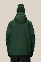 A person is shown from the back wearing the 686 Men's Foundation™ Insulated Jacket by 686 along with a matching green beanie and black gloves against a plain beige background.