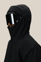 A man in a 686 Men's GORE-TEX GT Thermagraph® Jacket and large black reflective ski goggles is shown from the side against a plain beige background.