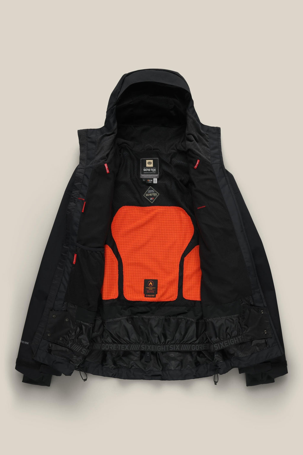 The 686 Men's GORE-TEX GT Thermagraph® Jacket in black is open to reveal a bright orange mesh back panel, black lining, multiple interior pockets, and visible 686 and GORE-TEX branding near the bottom hem.
