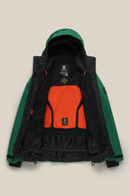 The 686 Men's GORE-TEX GT Thermagraph® Jacket is a green waterproof woven jacket with a hood, bright orange mesh back panel, black inner lining, neck and waist labels, and adjustable cuffs. Made by 686 with GORE-TEX material.