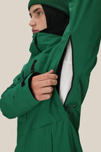 A person wearing the 686 Men's GORE-TEX GT Thermagraph® Jacket in green and a beanie unzips an underarm vent, revealing a white layer beneath.