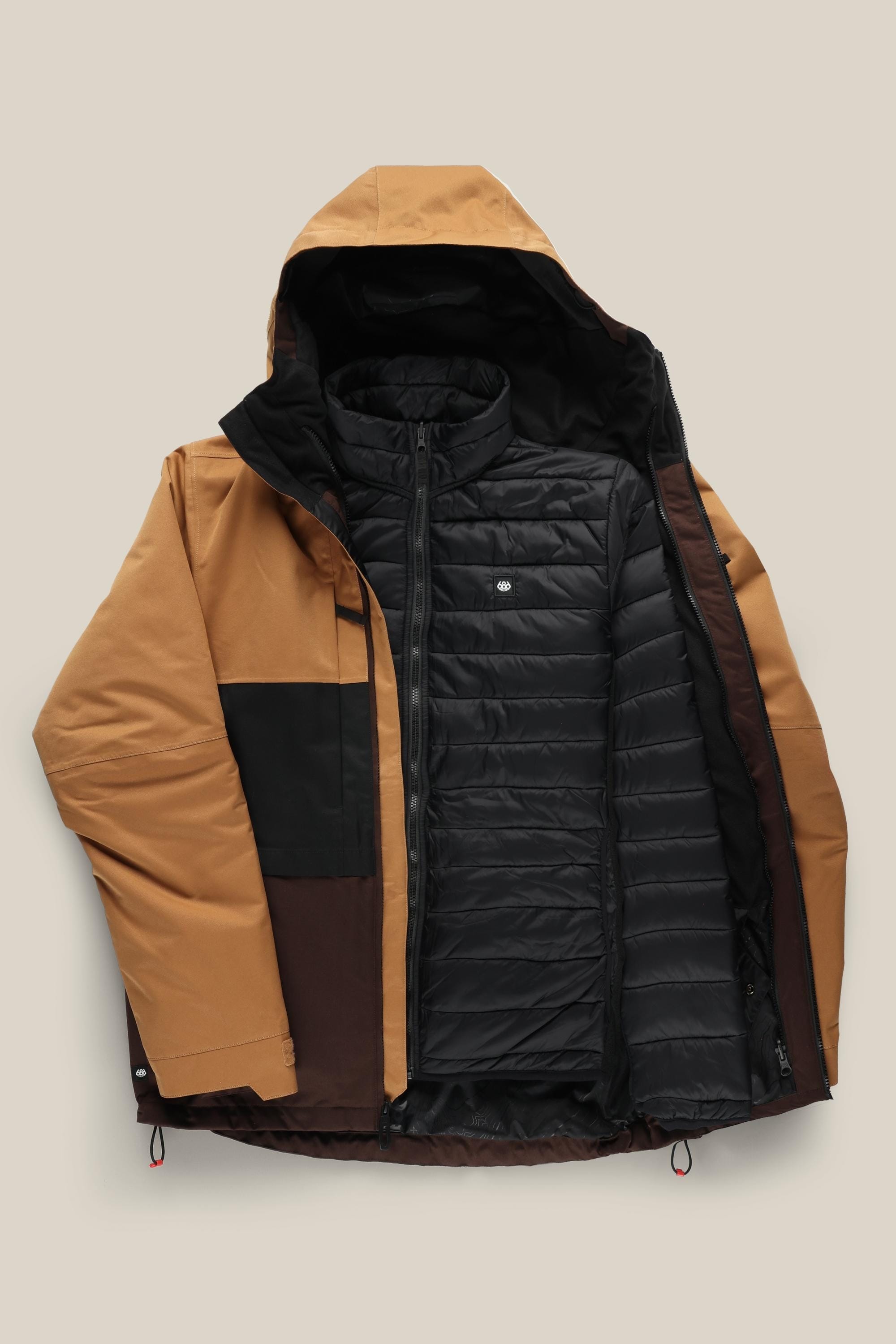 The 686 Men's SMARTY® 3-In-1 Form Jacket features tan, brown, and black color-blocked waterproof polyester with a black quilted inner layer, unzipped on a neutral background, and drawstrings at the hem for a secure fit.