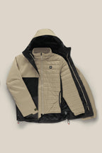 The 686 Men's SMARTY® 3-In-1 Form Jacket is shown in beige and black on a neutral background, partly unzipped to display the matching quilted inner jacket with a chest logo and zippered pockets.