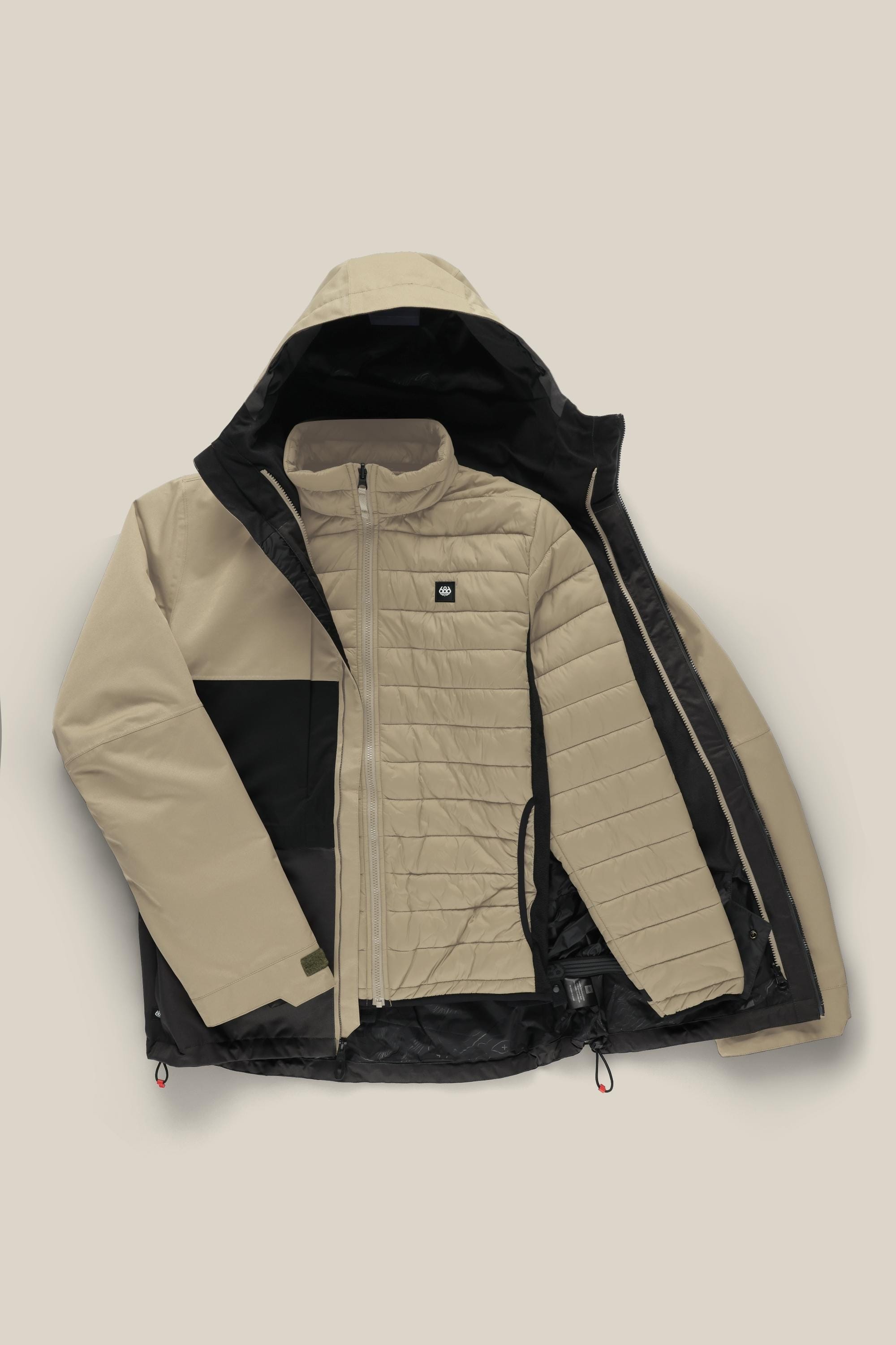 The 686 Men's SMARTY® 3-In-1 Form Jacket is shown in beige and black on a neutral background, partly unzipped to display the matching quilted inner jacket with a chest logo and zippered pockets.