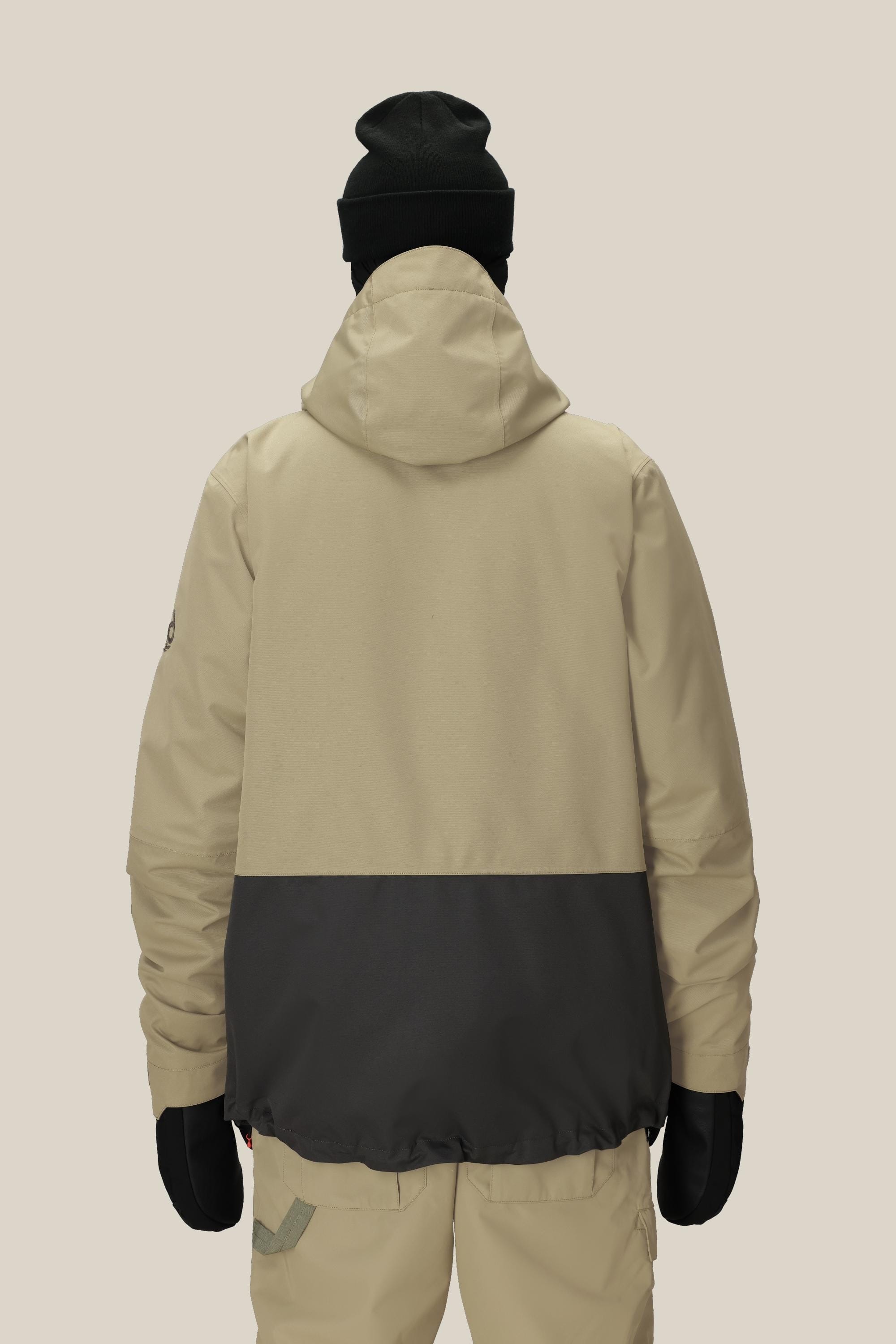 Against a plain light background, a person is shown from the back wearing the 686 Men's SMARTY® 3-In-1 Form Jacket in beige and black, along with beige pants, black gloves, and a black beanie.