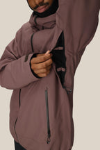 A person wearing the 686 Mens Gateway Shell Jacket unzips a black mesh-lined underarm vent, revealing the interior. Only the lower part of their face is visible.