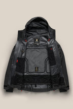 The 686 Men's GORE-TEX 3L ATV Thermagraph® Jacket—shown in black and laid flat on a beige background—displays its interior lining, mesh pockets, labels, and technical features.