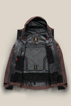 The 686 Men's GORE-TEX 3L ATV Thermagraph® Jacket in maroon and gray is laid open on a beige background, showing its black and gray insulated panels, mesh pockets, and multiple Gore-Tex and brand label tags.